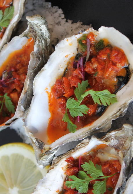 Grilled Oysters In A Chipotle, Bacon And Onion Butter